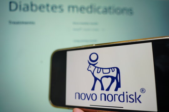 Roosendaal, The Netherlands - February 19, 2025:.A mobile phone displaying the logo of Novo Nordisk, with the company website in the background.