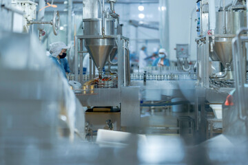 Food production workers handling fish for canning on an automated conveyor system Highlights of precision and quality assurance in industrial workflows.