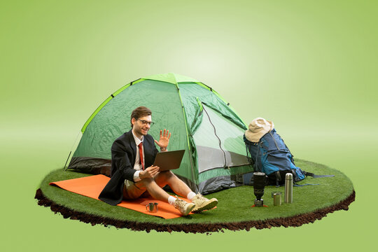 Composite image of businessman sitting outside tent on floating island, waving at laptop during video call against gradient green background. Concept of digital work, online communication, hybrid work - Powered by Adobe