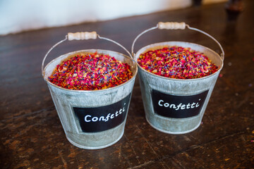 Rustic Buckets Filled with Colorful Petal Confetti for Celebratory Events