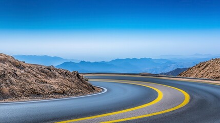 Asphalt Road Curves Through Mountain Landscape Under Blue Sky