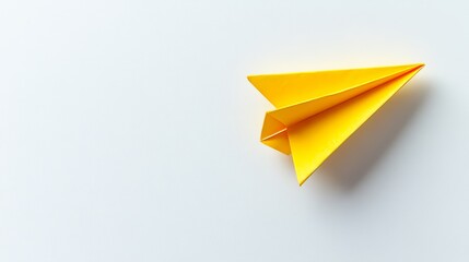 A paper airplane resting on a white backdrop, symbolizing business competition