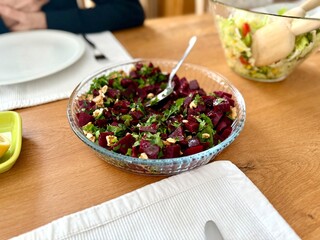 Homemade healthy beetroot salad or beet with fresh greens and walnut