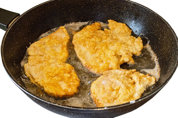 The cooking process in a pan of fried chop in batter.