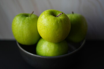 green apples in a black bowl