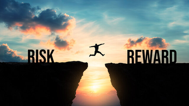 Silhouette of a person jumping from risk to reward over a gap between cliffs at sunset, taking chances for success, high-risk high-reward concept, courage, investment, business opportunities

