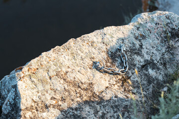 A chain is laying on a rock