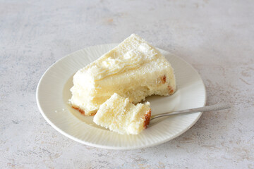 Creamy Vanilla Cake Slice on the saucer with teaspoon