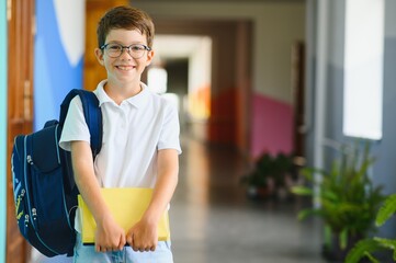 Portrait confident schoolboy in school corridor