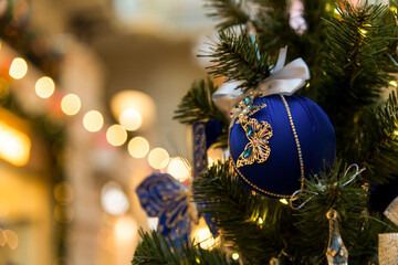 Blue ornament on a beautifully decorated Christmas tree