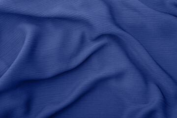 Elegant blue fabric texture with soft flowing folds and creases	
