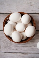 Raw uncooked white eggs in a basket, selective focus