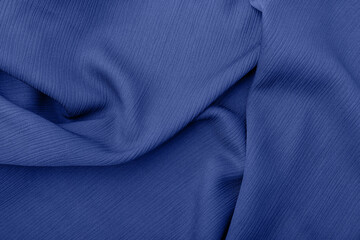 Elegant blue fabric texture with soft flowing folds and creases