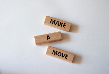 Make a Move symbol. Concept words Make a Move on wooden blocks. Beautiful white background. Business and Make a Move concept. Copy space.