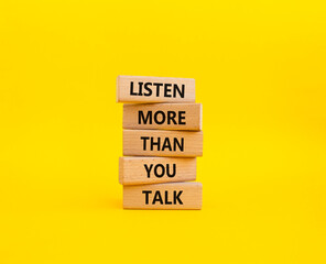 Listening skills symbol. Concept words Listen more than you Talk on wooden blocks. Beautiful yellow background. Business and Listen more than you Talk concept. Copy space
