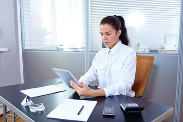 Young businesswoman sitting at workplace