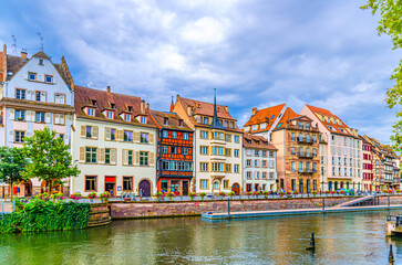 Medieval buildings old colorful houses on Quai des Bateliers embankment River Ill canal water in...