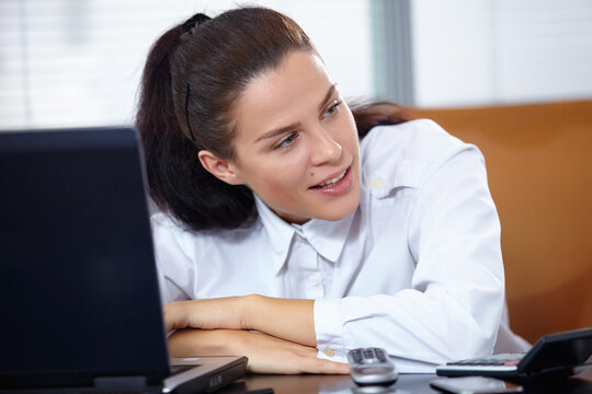 Young businesswoman sitting at workplace