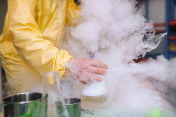 An animator conducts an experiment, a chemical experiment with liquid nitrogen on a table, showing...