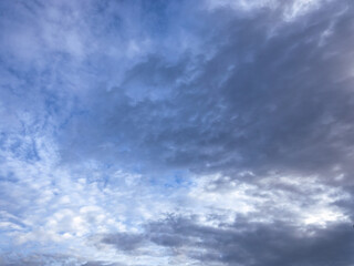 A vast blue sky with scattered clouds forms a dreamy, calm scene. The clouds vary in size and shape, adding depth and texture to the beautiful landscape