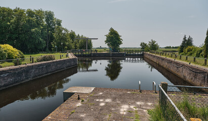 Fototapeta premium Historic Driewegsluis Water Lock in Nijetrijne, Friesland, Netherlands
