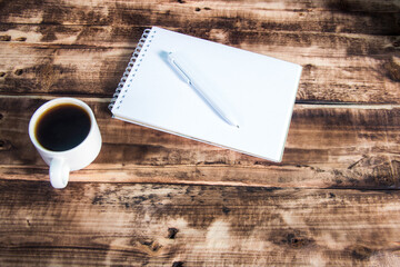 Open notebook with pen and coffee in studio