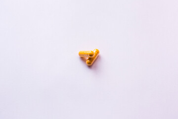Yellow pills  on white background.