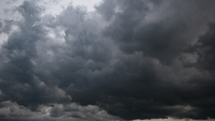 The dark sky, heavy with swirling clouds, signals an impending windstorm, highlighting the dramatic changes in weather and the immense power of nature.