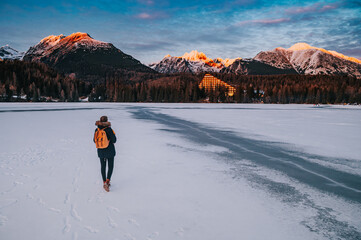 Female Hiker and Tatra Mountains, winter landscape, Strbske pleso, Slovakia