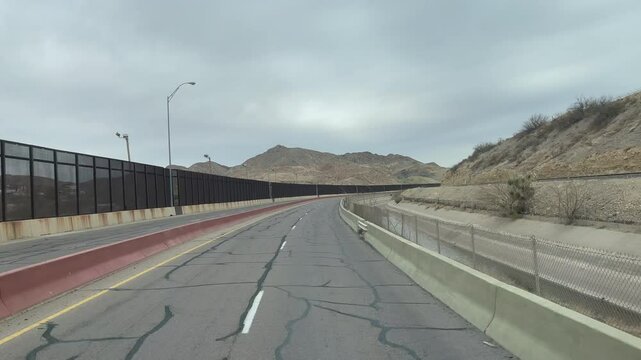 Driving by USA Mexico Border Wall