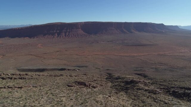 Aerial of Warner Valley St George Utah red sandstone mesa with blue sky