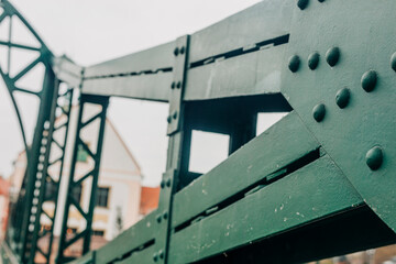 Green Bridge in Wroclaw, Poland, is a vintage, riveted steel structure showcasing the industrial design of the 20th century.