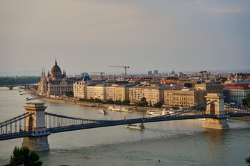 Fototapeta premium Aerial view of Budapest, Hungary with Chain Bridge over Danube River and Parliament Building at sunset. Neo Gothic architecture and famous landmark of Hungary