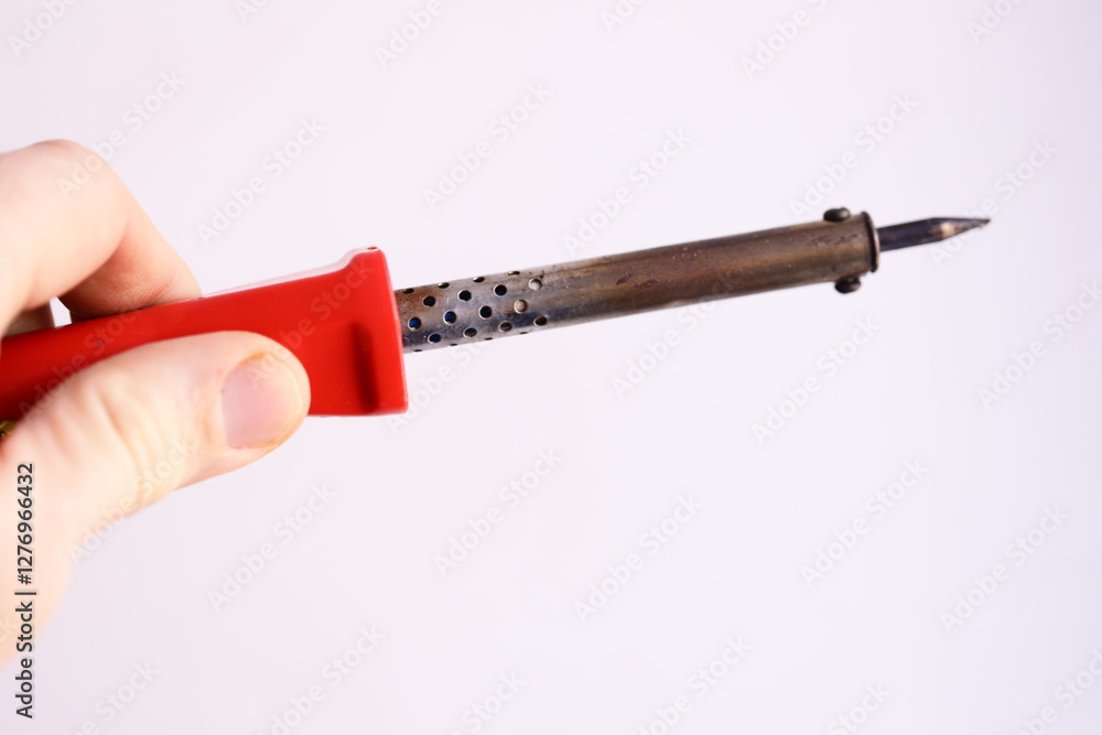 Poster A person holding a small red object in their hand, perfect for use in various scenarios such as still life compositions or illustration.