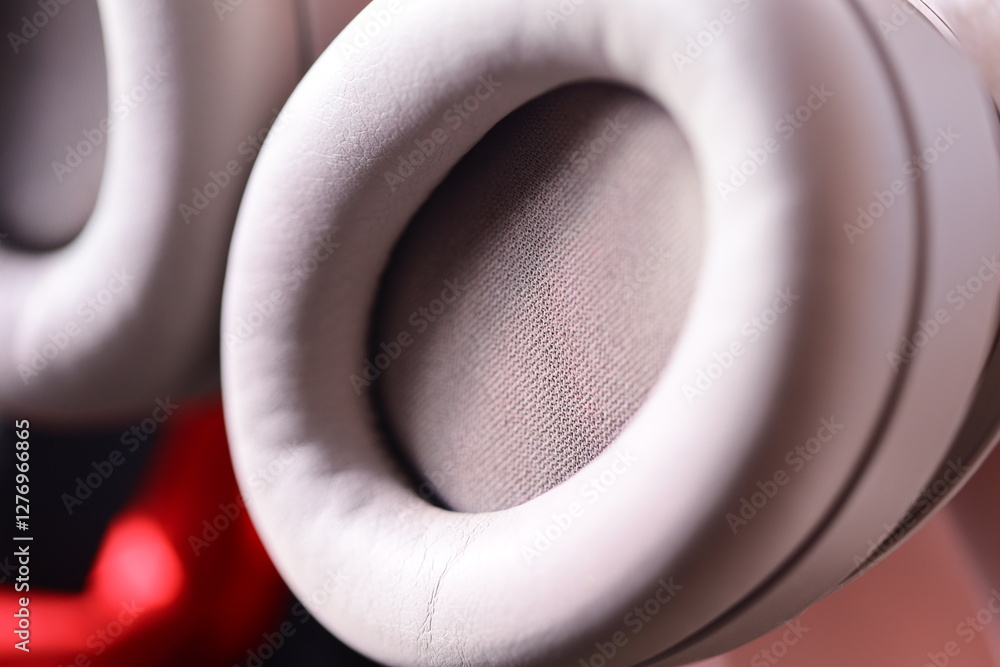 Poster a close-up shot of a pair of white headphones, ideal for use in technology and electronics related d
