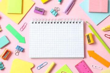 Flat lay with school stationery with notebook on pink background, top view