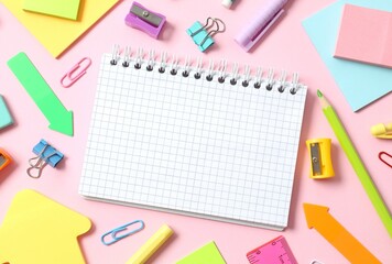 Flat lay with school stationery with notebook on pink background, top view