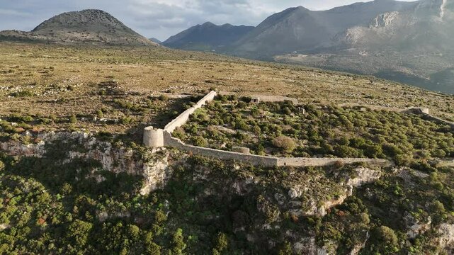 Aerial shot of entire Kelefa Castle near Oitylo sea bay at sunset, Mani, Laconia, Greece.
