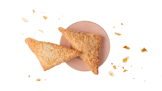 Whole fresh baked pastry puff pie apple turnover on pink vintage plate with crumbs isolated on white background.