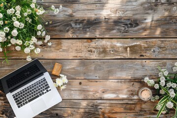 white flowers with laptop on empty wooden table top view