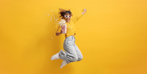 Happy woman with 3d cinema glasses against a yellow background