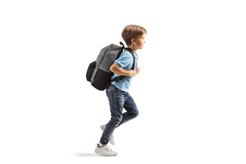 Full length prodile shot of a boy running with a backpack