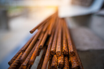 Rusty construction rebar close-up. Corrosion affects exposed metal outdoors