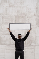 African activist is holding a sign of protest. Speaking up for equal rights and freedom. Making...