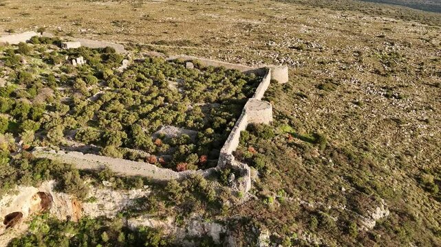 Aerial shot of entire Kelefa Castle near Oitylo sea bay at sunset, Mani, Laconia, Greece.