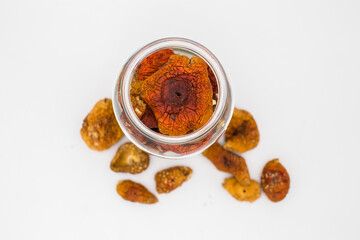 Dried amanita mushrooms in a glass jar.