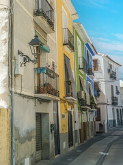 Narrow street with colorful houses in Villajoyosa, Spain