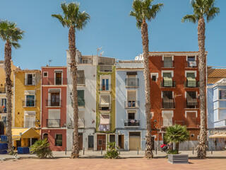 Colorful Mediterranean Houses With Palm Trees Under Clear Blue Sky, Villajoyosa, Spain
