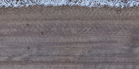 view from above on texture of dry road with tractor tire tracks in countryside. © hiv360