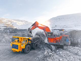 Open pit coal mining in industry landscape with heavy big truck machinery